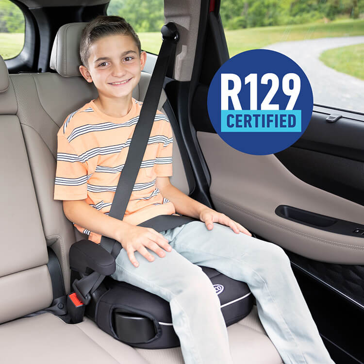 Young boy sitting and smiling in Graco Booster Deluxe R129 backless booster car seat
