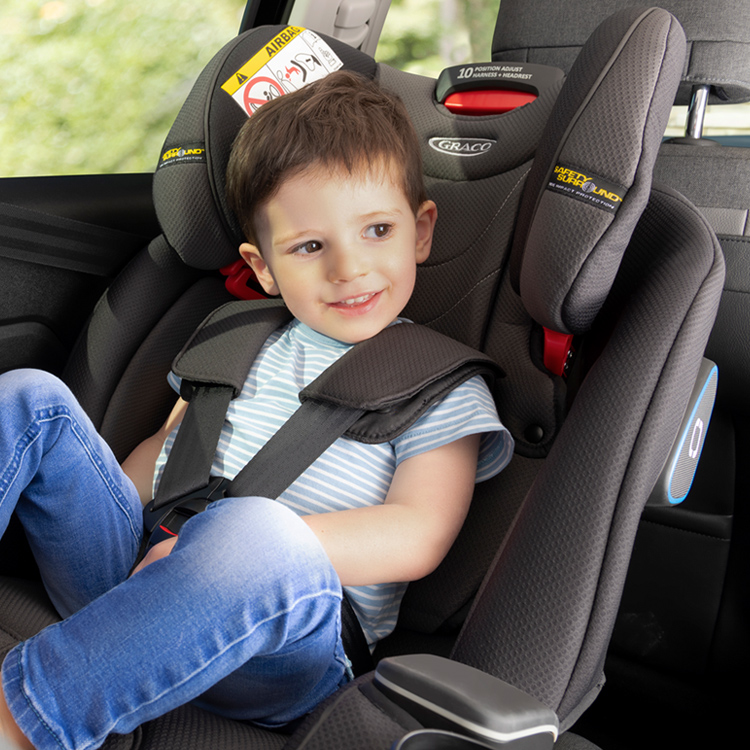 LIttle boy sitting forward facing in Graco SlimFit car seat