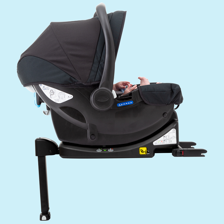 Baby sitting in  Graco SnugEssentials i-Size car seat on Graco IsoFamily i-Size ISOFIX base on blue background.