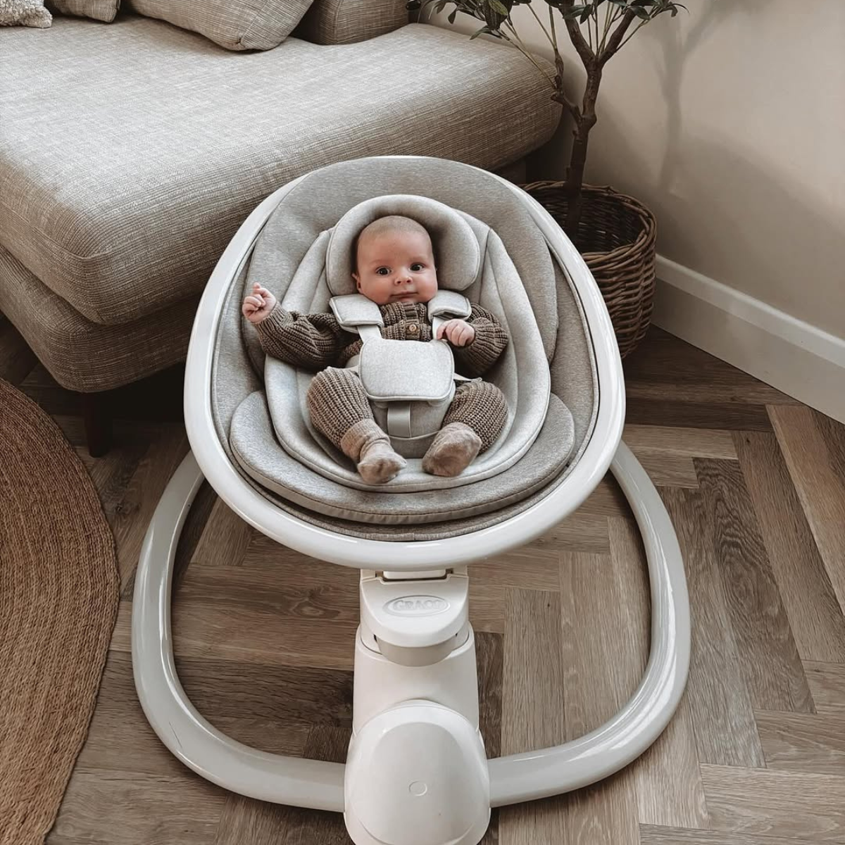 Mum with baby walking outside with Graco Myavo stroller.