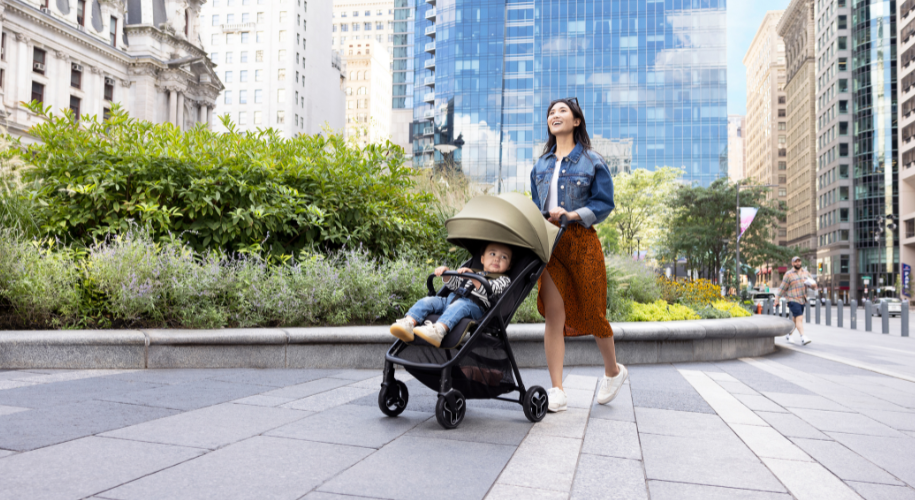Mum pushing baby in Graco Myavo quick-folding travel stroller