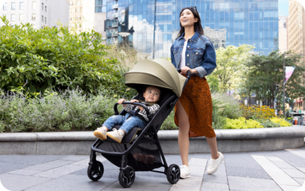 A mum outside pushing a young child in Graco Myavo Stroller 